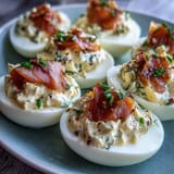 Deviled eggs filled with smoked salmon and zesty Dijon, garnished with everything bagel seasoning for a brunch-worthy appetizer.
