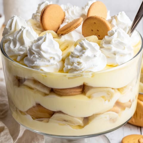 Classic Southern Banana Pudding dessert in a glass trifle bowl, showcasing creamy layers and golden vanilla wafers.