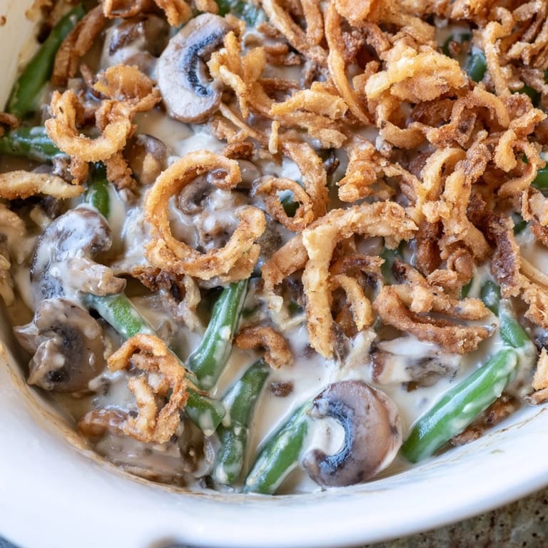 Green bean casserole with tender vegetables and rich sauce, ready for a holiday table serving.