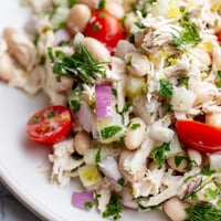 Tender shredded chicken, creamy white beans, and crisp celery tossed in a zesty lemon vinaigrette for a light, protein-packed salad.